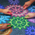 Gears drawn on the ground with colourful chalk
