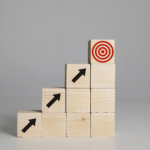 wood blocs that are shaped as steps with the image of a target at the top