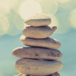 Stones balance at the beach, stack over blue sea