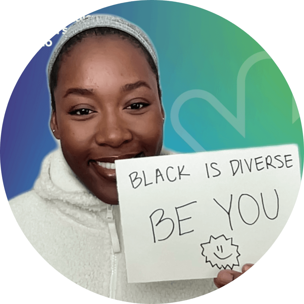 Joyce holding a sign - Black is diverse be you