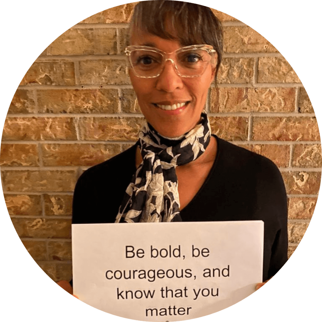 Patricia holding a sign - Be bold, be courageous, and know that you matter
