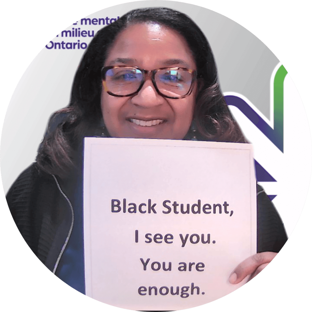 Tracey holding a sign - Black student, I see you. You are enough.